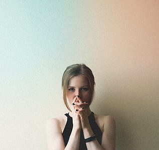 woman wearing black halter top leaning on wall thumbnail