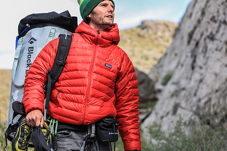 man standing near green trees thumbnail