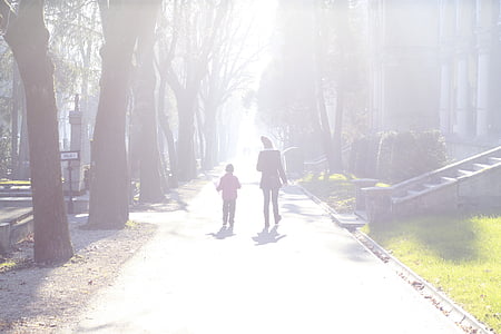 woman and child walking on sidewalk thumbnail