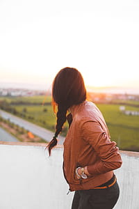 Woman Wearing Brown Leather Jacket Standing and Looking on Grass Field View at Day Time thumbnail