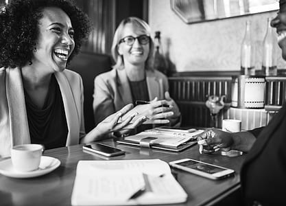 two woman sitting in front of the desk thumbnail