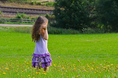 girl walking on grass field thumbnail