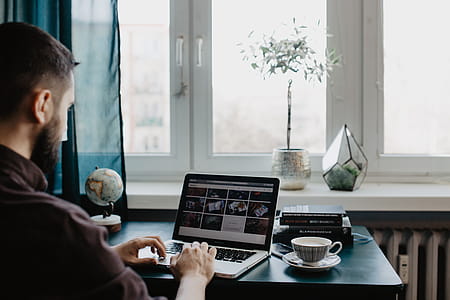 Male working with a laptop and a cup of coffee thumbnail
