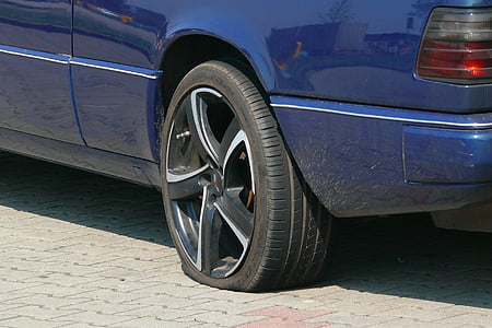 blue vehicle with flat rear tire thumbnail
