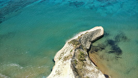 island with green trees next to sea water thumbnail