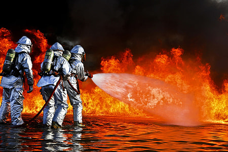 three firefighters pointing water hose on flame thumbnail