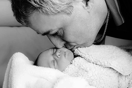 man kissing baby sleeping thumbnail