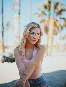 shallow focus photography of blonde haired woman wearing eyeglasses and pink tank top thumbnail