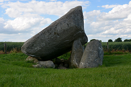 gray stone form surrounded with green grass thumbnail