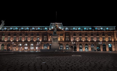 brown building with lights during nighttime thumbnail