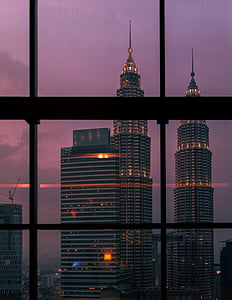 two tower buildings during nighttime thumbnail