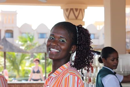 woman smiling near white post thumbnail