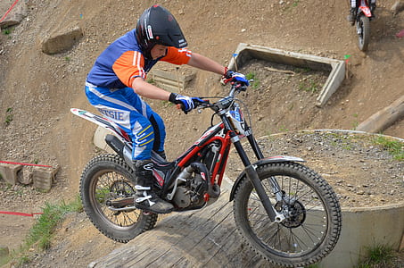 boy riding motocross bike on field thumbnail