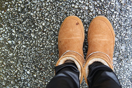 person wearing brown winter boots thumbnail
