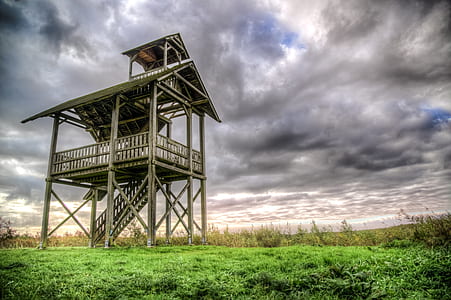 grey wooden barn on green grass field thumbnail