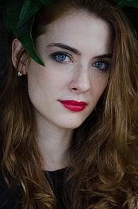 woman wearing green headdress and red lipstick thumbnail