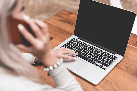 Woman Calling While Working Remotely on Laptop thumbnail