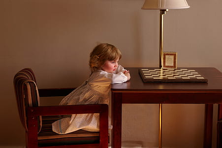 Child Setting on Chair in Front of Table thumbnail