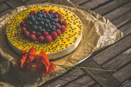 yellow and white icing covered cake on top of table thumbnail