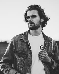 Grayscale Photo of Man Wearing Denim Jacket thumbnail