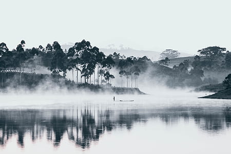 person sailing on body of water in mist thumbnail