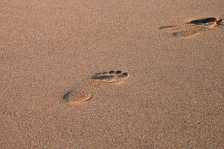 brown sand with foot steps during daytime thumbnail