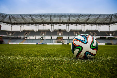 white and multicolored adidas soccer ball on field at daytime thumbnail