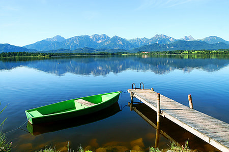 green boat docking on brown wooden body of water dock thumbnail