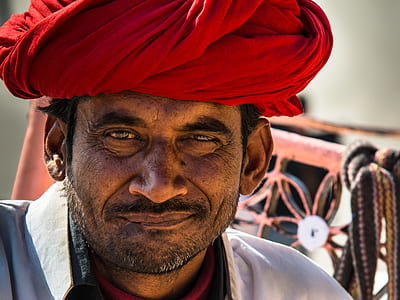 man wearing red turban and white shirt thumbnail