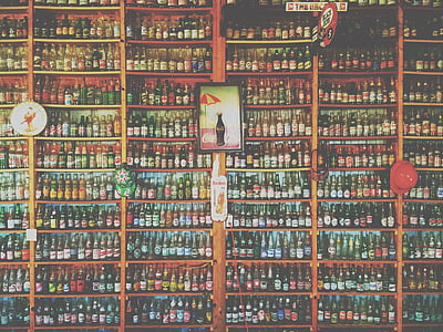 assorted-color bottle in brown rack thumbnail
