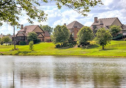 photo of brown houses near body of water thumbnail