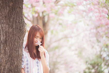 woman smelling flower thumbnail
