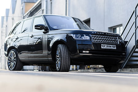black Land Rover Range Rover SUV parked grey near metal stairs thumbnail