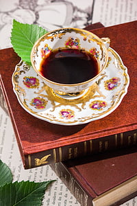 white and multicolored-print teacup with saucer thumbnail