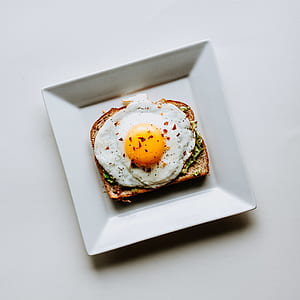 bread with sunny side up egg sandwich on plate thumbnail