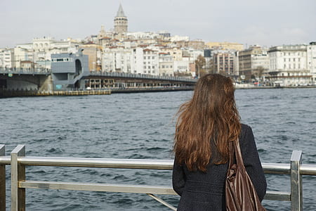 woman standing at terrace looking at the sea thumbnail