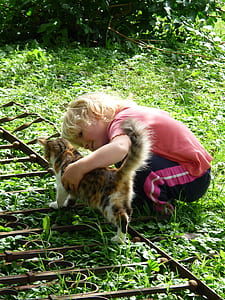girl holding orange and black cat thumbnail