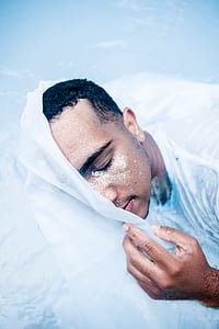 person holding white textile thumbnail
