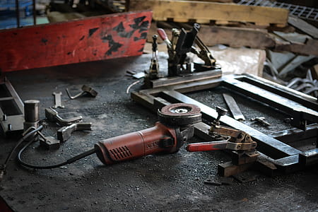 gray angle grinder on workbench thumbnail
