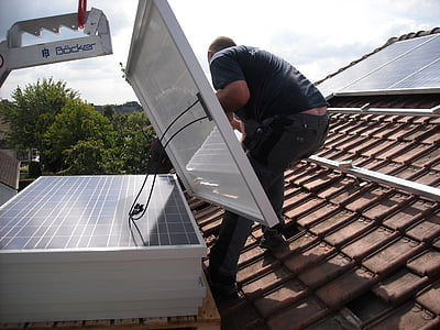 person installing solar panels during daytime thumbnail