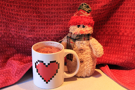 white ceramic mug beside Snowman figurine thumbnail