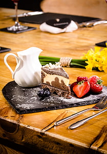 slice of brown and white cake on brown wooden top thumbnail