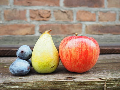 selective focus photography of red apple beside yellow fruit and blueberries thumbnail