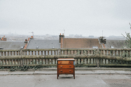 closeup photo of brown wooden lowboy dresser near on wooden balustrade thumbnail