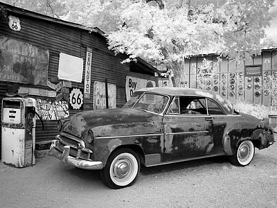 black vintage car near tree and house thumbnail
