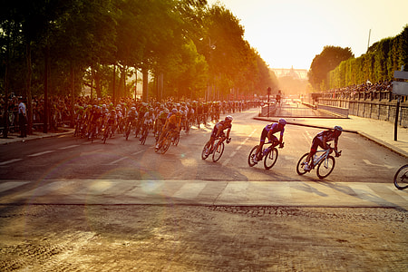 men cycling on road during daytime thumbnail