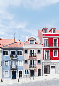 three blue, pink, and red concrete houses thumbnail