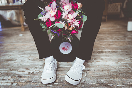 person sitting on ground holding flowers thumbnail