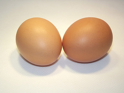 two brown eggs on white surface thumbnail