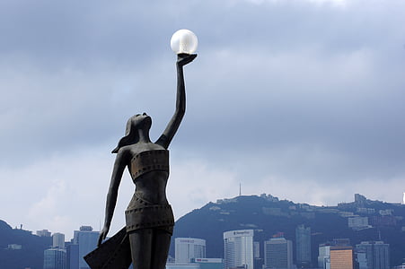 woman raising clear glass globe thumbnail